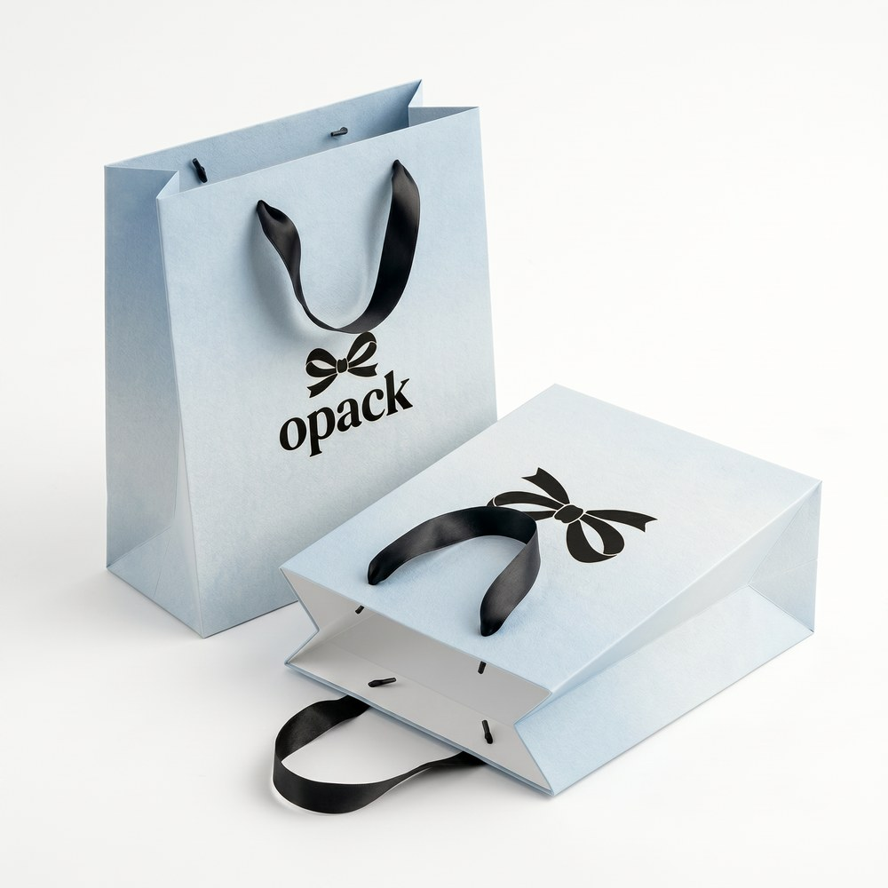 Custom minimalist paper shopping bags — clean white and pastel tone with subtle logo printing