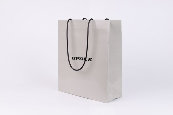 Clean white minimalist paper shopping bag with single colour logo