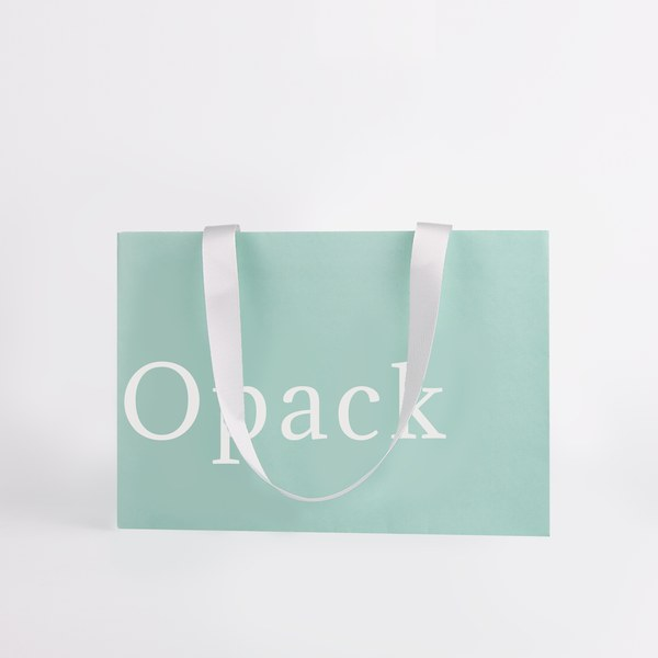 Soft neutral pastel tone minimalist paper shopping bag with restrained branding