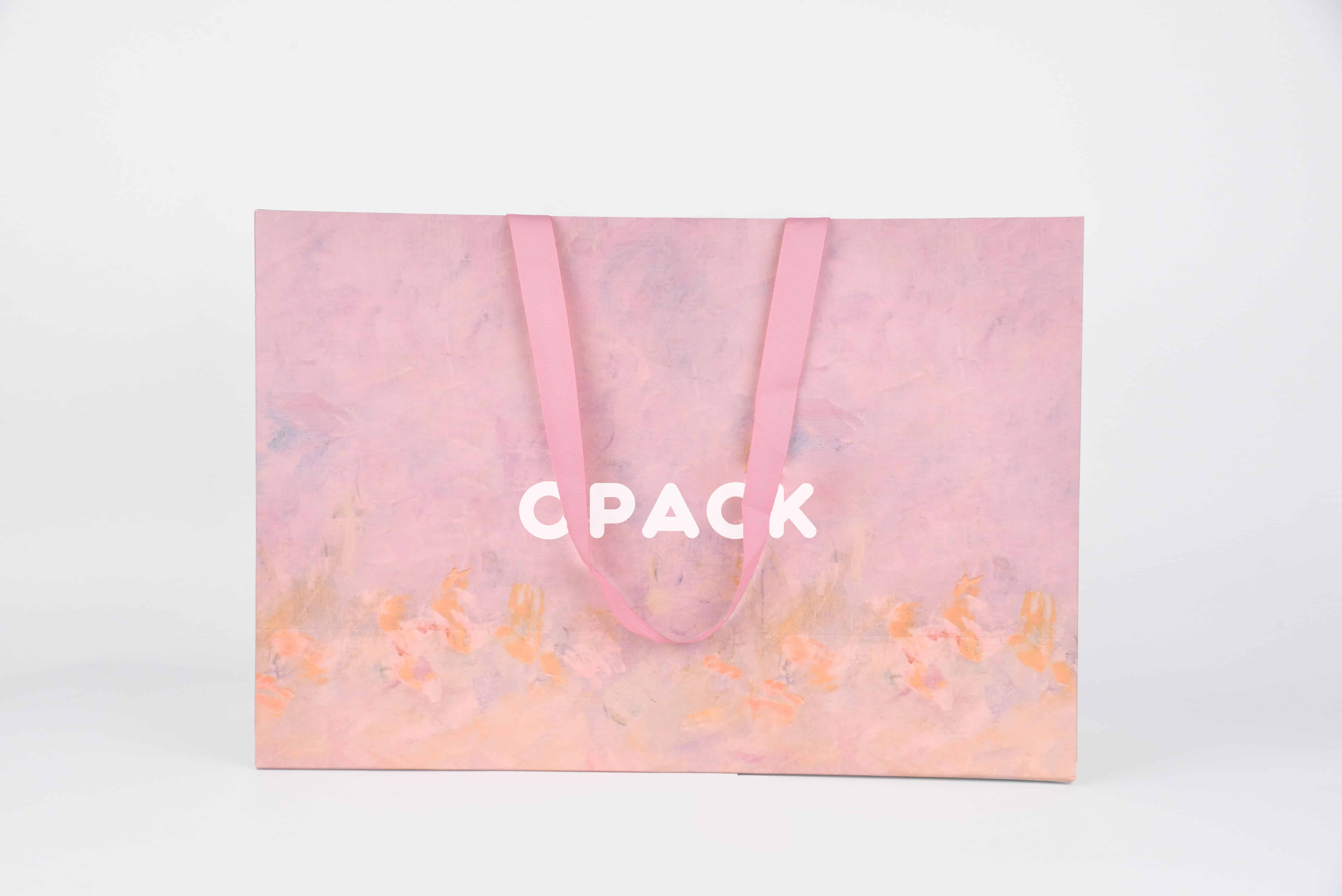 Soft pink gradient paper shopping bag with white brand logo print